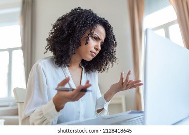 Confused Businesswoman Annoyed By Online Problem, Spam Email Or Fake Internet News Looking At Laptop, Female Office Worker Feeling Shocked About Stuck Computer, Bewildered By Scam Message Or Virus