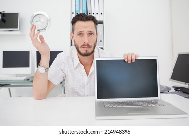 Confused Computer Engineer Looking At Camera With Laptop In His Office