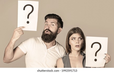 Confused Couples With Question Marks. Conflict Between Two People. Pensive Man And A Thoughtful Woman, Conflict. Portrait Of Couple Holding Paper Question Mark. Couple Thinking About Something.