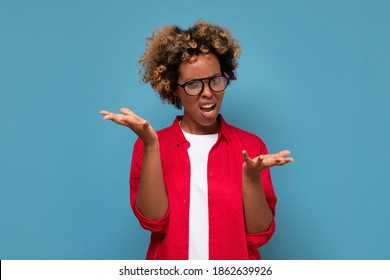 Confused doubtful shocked black woman shrugging looking at camera. Clueless african student being puzzled stunned unaware about ambiguous problem