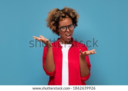 Confused doubtful shocked black woman shrugging looking at camera. Clueless african student being puzzled stunned unaware about ambiguous problem