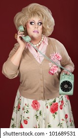 Confused Drag Queen On Phone Call Over Maroon Background