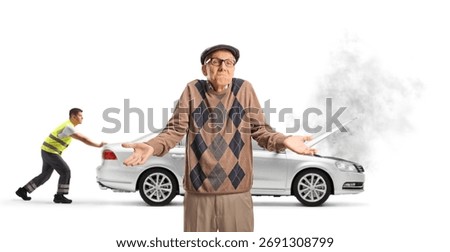 Confused elderly and roadside worker pushing an inoperable vehicle isolated on white background