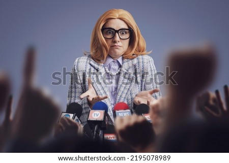 Confused embarassed female politician holding a press conference, she is talking to the media