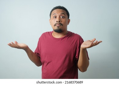 confused expression of young man isolated in white background