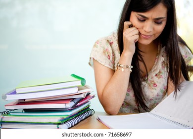 Confused Female Student With A Pile Of Notebooks