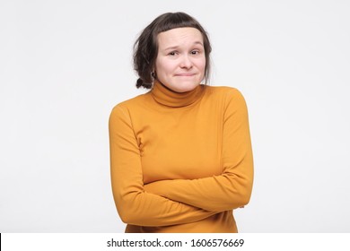 Confused Female Student In Yellow Clothes Feeling Awkward With Weird Smile After Making Mistake And Being Guilty, Saying Oops