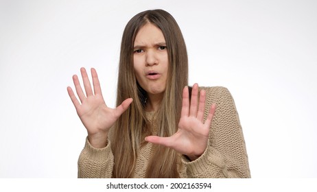 Confused Girl Showing Stop Or Calm Down Gesture With Hands