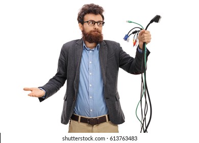 Confused Guy Looking At Different Types Of Electronic Cables Isolated On White Background