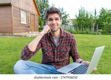 Confused handsome latin young freelancer with a laptop working outside on the grass with a cute smile - Shutterstock ID 1747936010