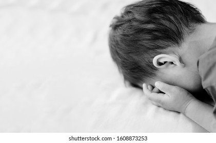 Confused Kid Crying Boy In The Bed.little 3 Years Old Asian Boy Crying And Sad.Orphan Child, Poor Children, Broken Family.Black And White Tone.