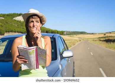 Confused Lost Woman On Car Roadtrip Travel Problem Searching In Road Map.