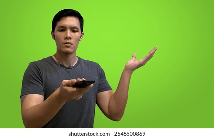 Confused man holding broken tv remote control, one hand raised, isolated on green screen background. - Powered by Shutterstock