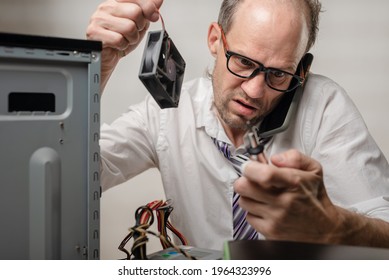 Confused Man Holding Computer Fan And Talking With Technical Support