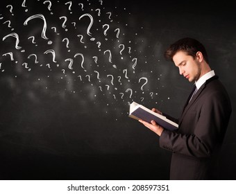 Confused Man Reading A Book With Question Marks Coming Out From It