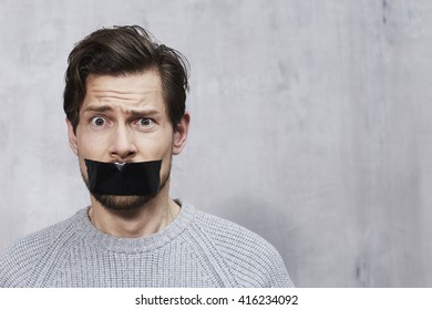 Confused Man With Tape Over Mouth, Portrait