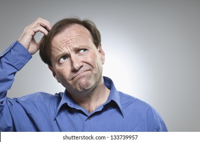 Confused Mid-Adult Man Scratching His Head