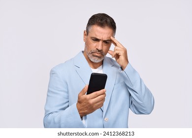 Confused middle aged business man, older professional businessman manager wearing suit using cellphone looking at smartphone reading message on mobile phone standing isolated on white background. - Powered by Shutterstock