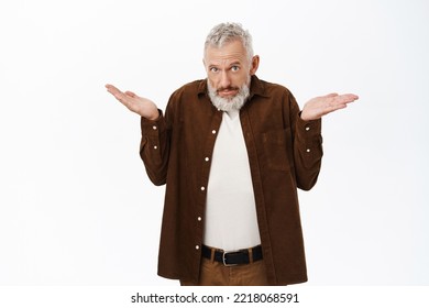 Confused Old Man, Senior Guy With Beard And Grey Hair Shrugging Shoulders, Looking Clueless, Standing Over White Background