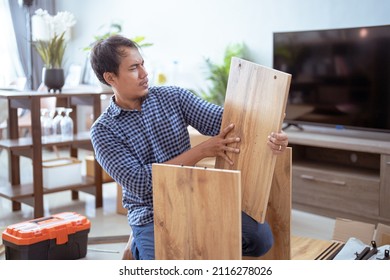 Confused Person While Assembling New Furniture At Home