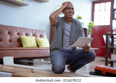 Confused Person While Assembling New Furniture At Home