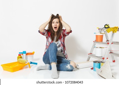 Confused Screaming Mad Shocked Woman Sitting On Floor With Instruments For Renovation Apartment Isolated On White Background. Wallpaper, Accessories For Gluing, Painting Tools. Concept Of Repair Home