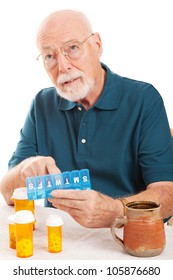 Confused Senior Man Can't Remember Whether Or Not He Took His Pills.  Could Be Early Sign Of Alzheimer's Disease Or Dementia.