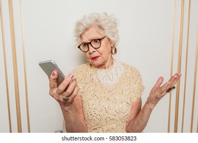 Confused Senior Woman Using Mobile Phone