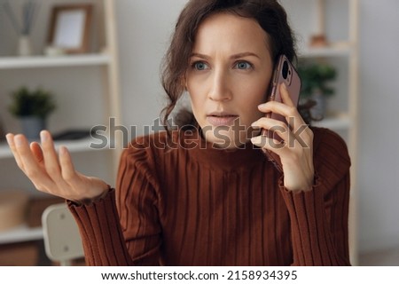 Confused shocked unhappy curly pretty female irritated quarrel with husband boyfriend or scandal with debt collectors in call have big mental problems need professional psychology help. Copy space