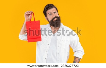 confused shopper man at shopping in studio. shopper man at shopping on background.