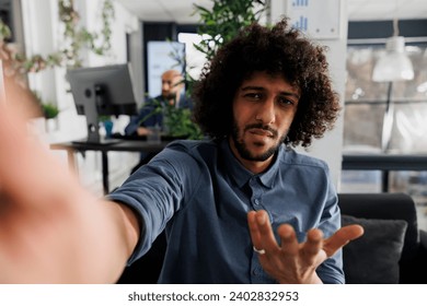 Confused start up company product manager discussing project with client on smartphone videocall and looking at camera. Business entrepreneur explaining analytics report to customer on mobile phone - Powered by Shutterstock