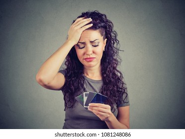 Confused Stressed Woman Looking At Too Many Credit Cards