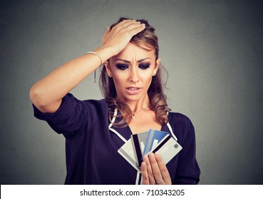 Confused Stressed Woman Looking At Too Many Credit Cards