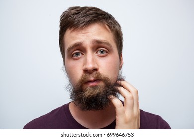 Confused And Uncertain Man Scratching Messy Beard