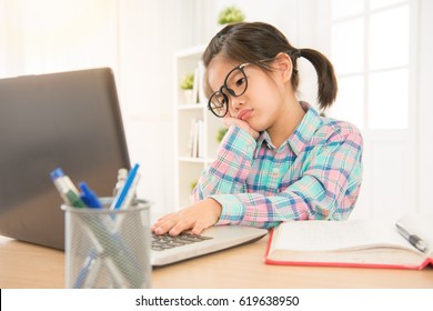 Confused Unhappy Teen Kid Watching Computer Screen Thinking Solution For Problem. Asia Beautiful Children Study With Online Depressed.