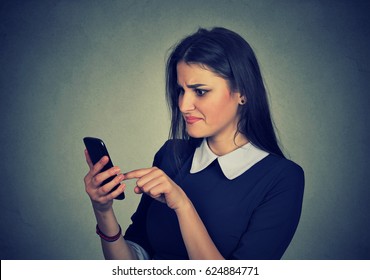 Confused Upset Woman Looking At Her Mobile Phone 