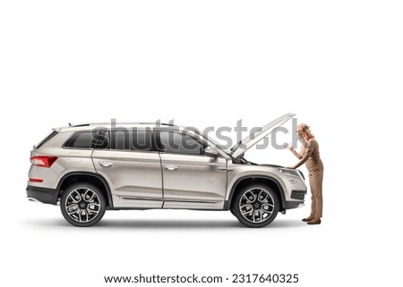 Confused woman with car problem looking at the engine isolated on white background



