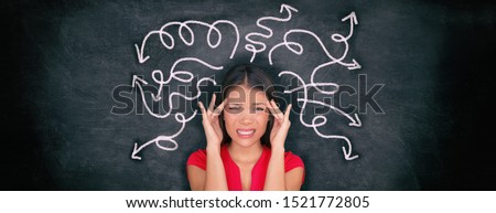 Confused woman confusion illustrated on blackboard with chalk drawing of arrows going everywhere around head showing indecision. Indecisive stressed Asian girl with headache panoramic banner.
