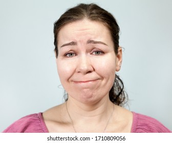 Confused Woman, Pursed Lips, Portrait On Grey Background, Emotions Series.