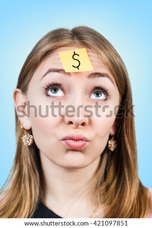 Confused woman with a sticker on her forehead