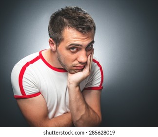 Confused Young Man Over Gray Dark Background, Annoying Guylooking To You, Close Up Studio Shot