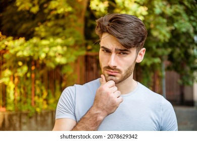 Confused Young Man Scratching His Head, Looking Up