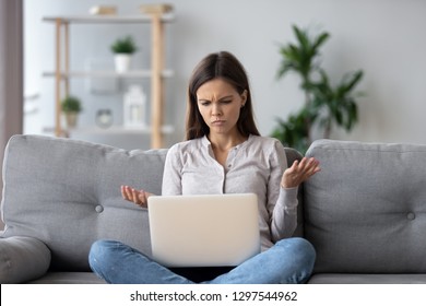 Confused Young Woman Looking On Laptop At Home Feeling Bewildered By No Connection, Reading Online News In Internet, Annoyed Teen Girl Angry With Stuck Computer Problem, Scam Spam Email, System Error