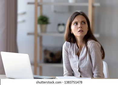 Confused Young Woman Sit At Office Home Desk Working At Laptop Look At Clock Realizing Missing Deadline, Frustrated Disappointed Girl Feel Puzzled Late For Appointment, Forget Meeting Or Gathering