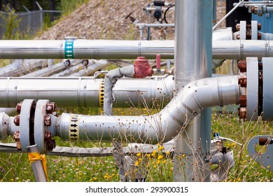 Confusing Complex Outdoor Piping System Of Shut-down Natural Gas Well Installation With Rusty Bolts