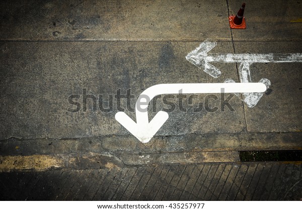 The confusion of traffic symbol on the road floor  -\
Arrow sign 