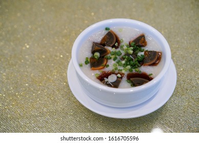 Congee with century egg. Chinese rice porridge served with century egg. A famous Chinese traditional breakfast. (Isolated)