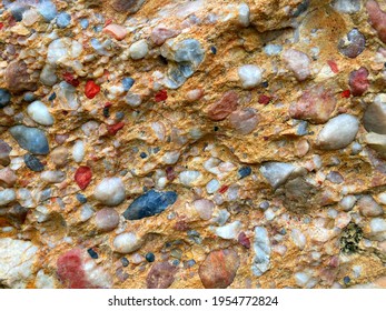 Conglomerate rock consisting rounded fragments different rocks, cemented pebble, cemented gravel, pebbles, boulders. Rounded rock fragments  bonded in solid rock by clay, limestone or siliceous cement - Shutterstock ID 1954772824