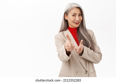 Congrats, You Got This. Smiling Beautiful Asian Business Woman, Pointing Fingers At Camera, Congratulating, Praising You, Standing Over White Background