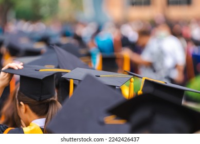 Congratulated the graduates in University  Rear view of the university graduates in graduation gowns and caps - Shutterstock ID 2242426437